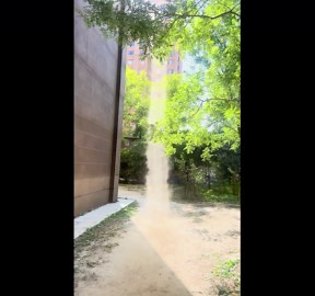 Dust devil tornado appears outside apartment block