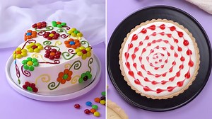 Colorful candy flower cake and heart-swirl tart