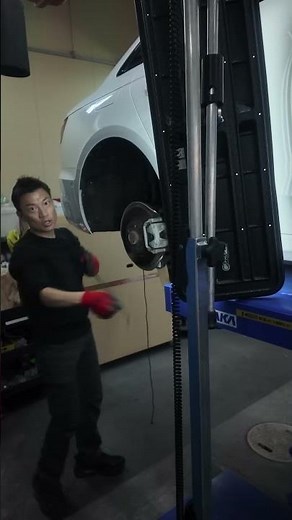 Repairing a dent on the quarter panel of an Audi A4 using paintless dent repair.