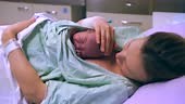 Mother and newborn. Child birth in maternity hospital. Young mom...