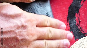 Patch repair kit with glue for inflatable boats, SUP, raft. Man repair inflatable sup on the beach.