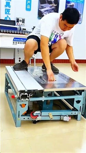 Hands steady, body low, machine’s flat surface holds weight while red knob waits for precise