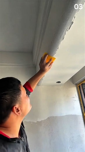 Smoothing ceiling joint with sponge during renovation