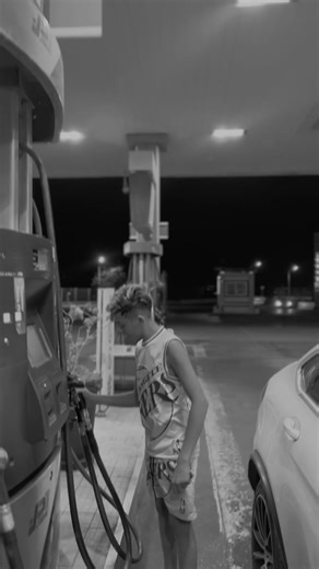 Young Male Basketball Fan at Gas Station