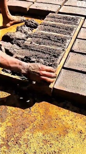 Filling rectangular molds with wet concrete mixture manually