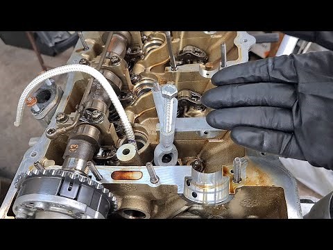 Using rope to hold valves during valve spring removal and valve stem seal replacement