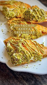 Pistachio Ashta Triangles aka Warbat bi Ashta 😋 these crunchy filo parcels are filled with a creamy dreamy clotted cream, drizzled with pistachio sauce & crushed pistachios! Each bite is heavennnnnn! Using only the best Ashta in town from @tarekabdelrahimelwazzicreamery ❤️ full recipe 👇 Warbat Bi Ashta Makes 12 For the pastry: 1 packet phyllo pastry, approx. 16-18 sheets 1 cup melted ghee OR clarified butter For the filling: 500g ashta @tarekabdelrahimelwazzicreamery Sugar Syrup: 2 cups sugar 