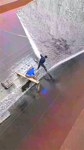 Real Engineerings | Engineering & Technology & Gadgets & DIY on Instagram: "This is the human element in industrial process engineering. ​What we're seeing is a critical task in bulk material handling, likely at an aggregate plant or quarry. The workers are inside a large feed hopper, and the man with the rake is doing one of the most important jobs in the plant: ensuring steady material flow. ​Bulk solids like gravel are notorious for sticking, bridging (arching over the outlet), or ratholing (