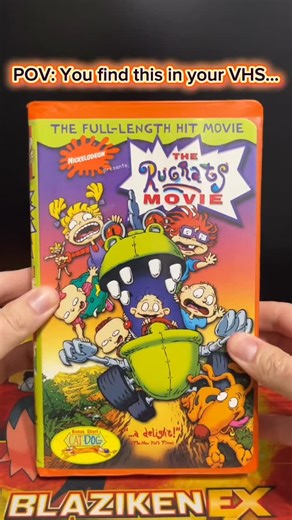 CueballCards | TCG Content Creator on Instagram: "Hey, I found a custom Reptarizard by @nathanmadeit in with my “The Rugrats Movie” VHS tape! Now I wonder how that got in there? 🤔 Regardless, this is one of the coolest crossovers I’ve ever seen, & if some day we do get a Pokémon X Rugrats crossover, this needs to become an official card! Check Nathan’s page out! • • • • #rugrats #pokemoncards #custompokemoncards #pokemontcg #reptar"