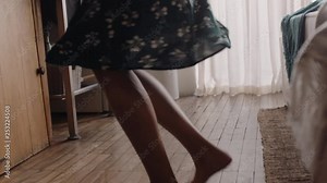 happy young woman dancing at home having fun celebrating summer vacation enjoying playful dance to celebrate successful lifestyle