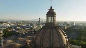 Breathtaking architecture design details in neo gothic style on the colorful domes and spire of Guadalajara Cathedral in Mexico. Drone flying close to decorated religion church roof.Latin cityscape 4K