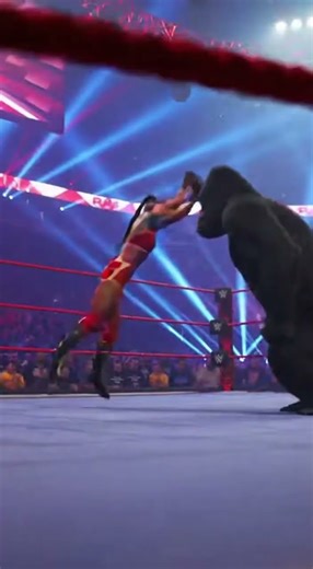 A furious girl wrestler faces an angry gorilla inside a full WWE style ring roaring crowd flashing