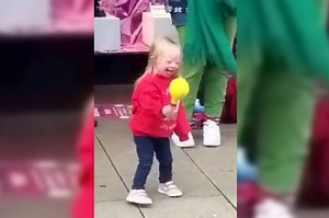 Video of adorable two-year-old girl with Down's syndrome dancing to buskers singing Christmas hits goes viral with 4 MILLION views