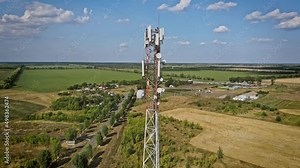 Cell site of telephone tower with 5G base station transceiver. Aerial view of telecommunication antenna mast