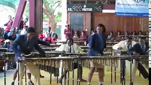 This is awesome:The marimba is a percussion instrument consisting of a set of wooden bars struck with mallets to produce musical tones. Resonators attached to the bars amplify their sound. A player of the Marimba can be called a Marimbist or a Marimba Player. | Our Africa Now