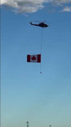 Stampede Opening 2026 Anthem with flag on helicopter