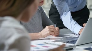 Two Coworkers Discuss A Project Looking At The Computer | Free Stock Video Footage