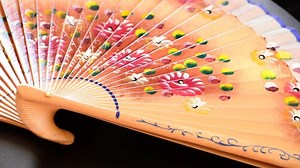 Download Decorated hand fan in rotation for free