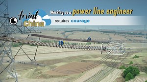 #Aerial #China: Working as a power line engineer requires courage (勇气 yǒng qì) Check out this dangerous (危险的 wēi xiǎn de) job in which power line engineers must climb 70-meter-high transmission towers to perform safety checks on the high-voltage transmission lines. At this height, strong winds force the workers to stay low and rely on their safety rope. An ability to work together makes it go more smoothly. Each worker must check eight kilometers of cables to find any potential problems. Sometim