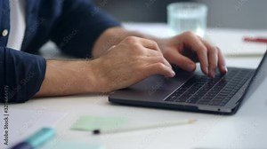 Close up man hands working laptop computer. Male professional typing computer