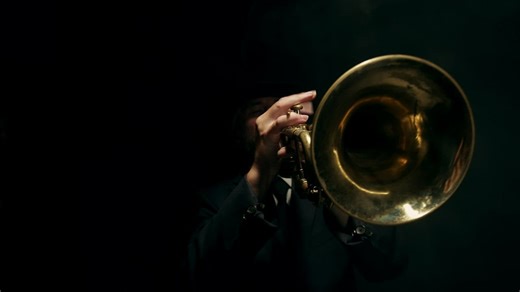 Close up of a trumpet being played on a black background - Free Stock Video