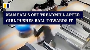 A man fell off a treadmill after a girl pushed an exercise ball towards the machine in southern China. | South China Morning Post