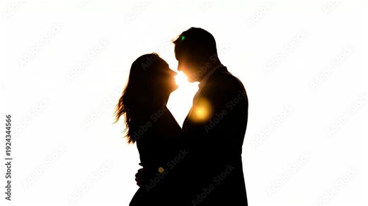 Responding to sunset light, romantic couple in suit and dress leaning in with sun backlight flare