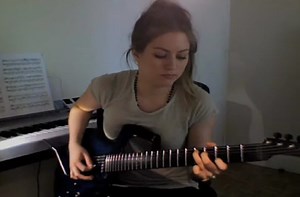 Girl shreds on guitar.