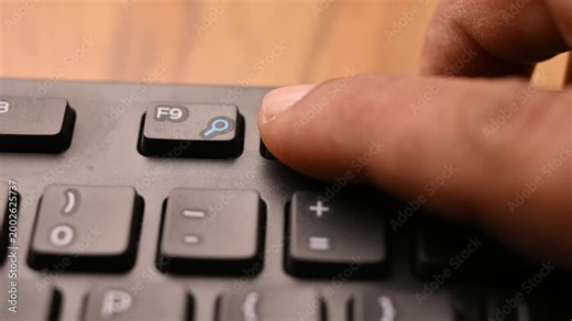 Man Pressing F10 Key on Keyboard to Activate Menu Bar on Computer