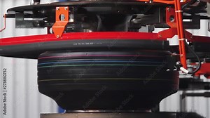 Tire Curing Molds. Tire production machine close up. Modern automated tyre forming tyres machine. Production process of tyres on modern equipment in the factory. Robotic machine in a tire factory.