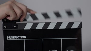 Download Clapper board. Close up hand and film making clapperboard isolated on background for free