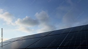 solar panel time lapse of clouds passing in blue sky covering the sun and the chagrin power of the battery