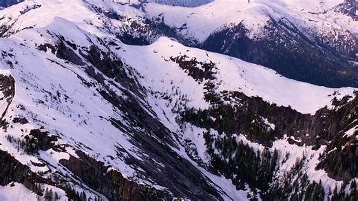 Silent alpine slopes blanketed in fresh white snow