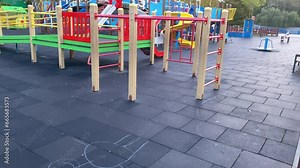 Large children's playground with roundabouts and swings in the park