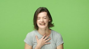 clip-1043328424-slow-mo-cheerful-attractive-woman-starts-laughing-cant