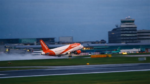Passenger jets lifting off from wet runways