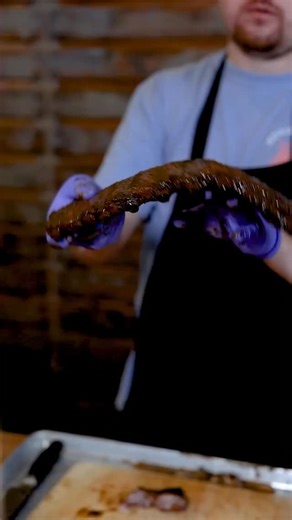 Wavy Rib Test 🍖 Perfect ribs don’t fall off the bone they bend with a juicy wave 🌊. That’s when you know they’re cooked just right. 🐷 | Hoggy's Restaurant & Catering