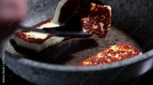 Fry halloumi cheese in a gray frying pan. Fried cheese in a pan.