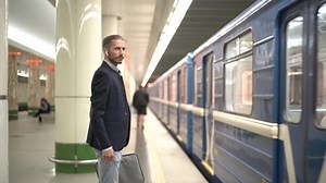 young man standing on the subway platform.