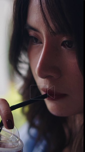close-up Young Asian woman drinking cold drink through straw relaxing near window quietly - FullHD Vertical Stock Video Footage - Alamy