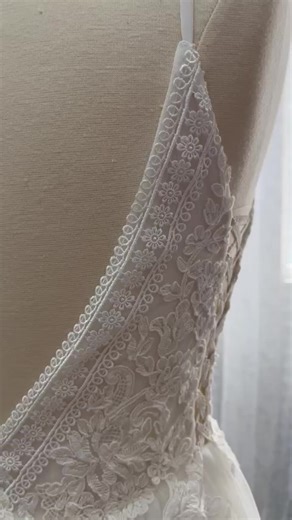 Crafted with intricate boho lace, our Daisy wedding dress is perfect for the free-spirited bride looking for a romantic and elegant style. The A-line silhouette flatters all body types while the cut-outs add a modern touch. With its lace-up closure, you can achieve the perfect fit for your special day. Shown in light ivory with laced sheer nude side cut outs, and cathedral length train. Note: One sample size US6 available with no extra modifications, as shown. Contact us for more information. Ab