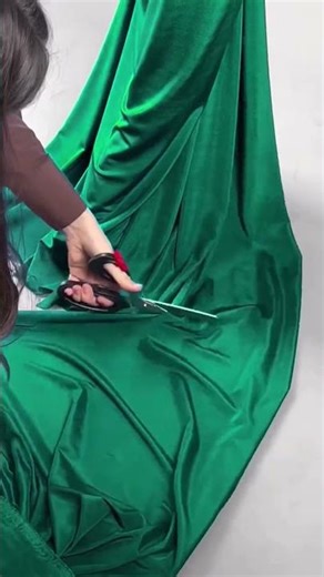 To order this emerald draped gown DM This sculpted silhouette features a halter neckline with a