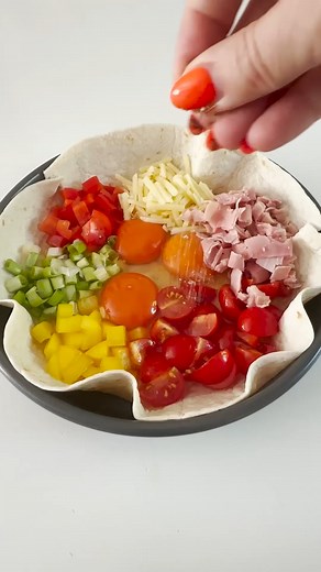 Tortilla Quiche - Such an easy lunch to make for yourself at home. Just add a large tortilla wrap to a baking dish with 3 eggs, grated cheese, some veggies and ham if you like. Bake at 180c for 17-18 minutes. | My Fussy Eater