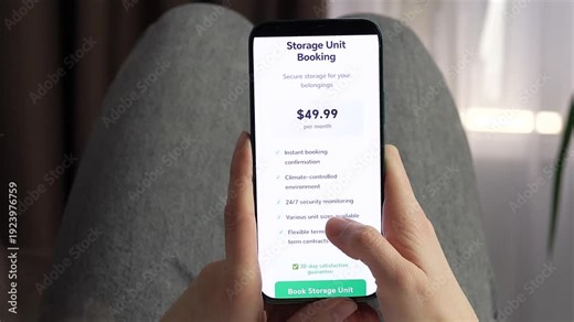 Woman booking a storage unit on smartphone at home, comparing price and features before confirming. Seamless mobile reservation with secure payment and instant confirmation. Trendy fintech and