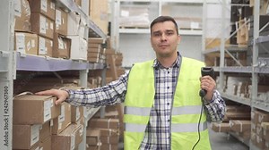 Man store worker using bar code scanner scanning labels on boxes