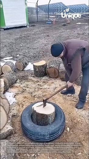 Chopping wood with an axe: person splitting wood inside a tire