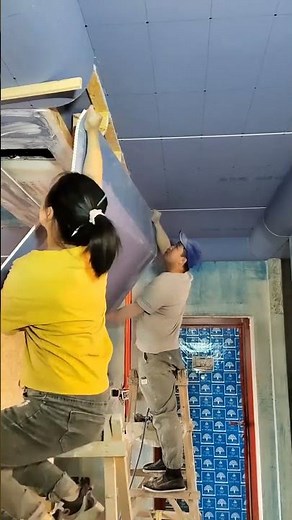 Carpenters demonstrate the process of installing an indoor suspended ceiling