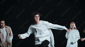 People in light-colored loose-fitting clothes are dancing a hip-hop street dance. There are both boys and girls here. The person in front is especially trying. They wave their arms and swing