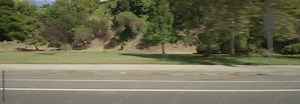 Right Side view of a Driving Plate: Car traveling on Temescal Canyon Road in Pacific Palisades, California, turns right onto Sunset Boulevard and continues to a stop light at the intersection of Via De La Paz. Stock Video