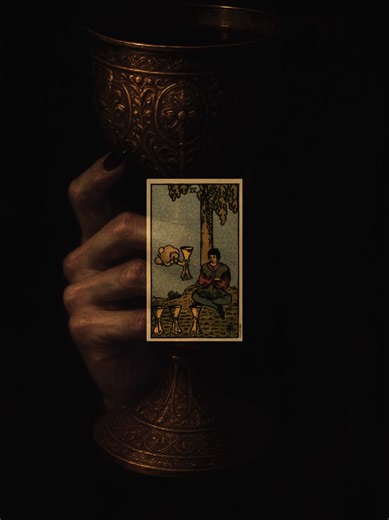 The Four of Cups depicts a figure sitting under a tree, seemingly disinterested in the three cups before him and ignoring a fourth cup being offered from a cloud. This imagery represents a state of contemplation and emotional detachment, where one may be so absorbed in their thoughts that they overlook new opportunities and blessings available to them. #fyp #viral #aesthetic #tarot #tarotcards